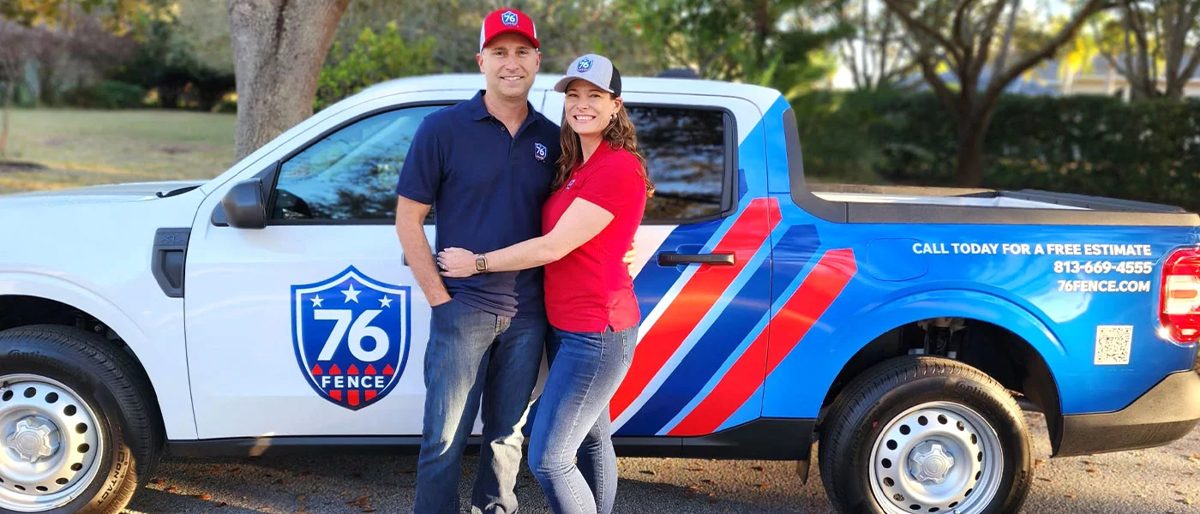 Tom and Kate Donnelly, owners of 76 FENCE Lutz, in front of their branded truck